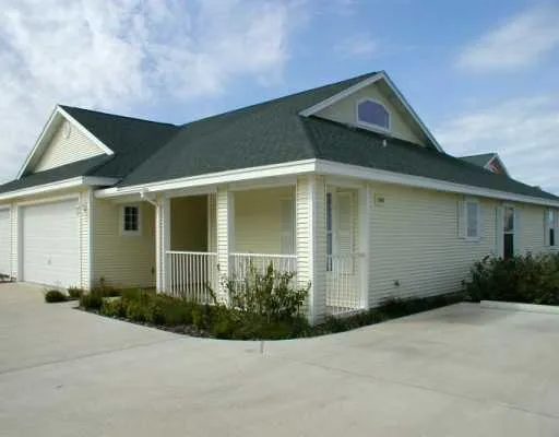front view of a house with potted plants
