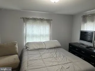a bedroom with a bed and flat screen tv