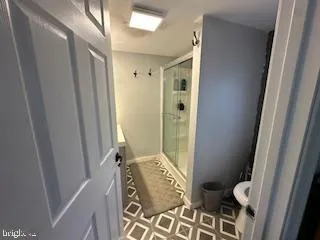 a bathroom with sink shower and toilet