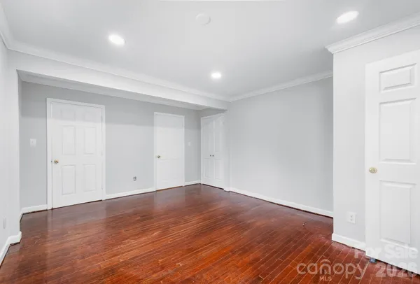 a view of an empty room with wooden floor