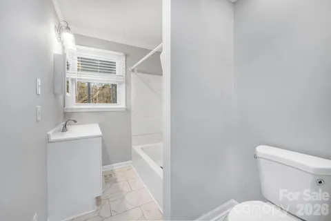 a bathroom with a toilet sink and window