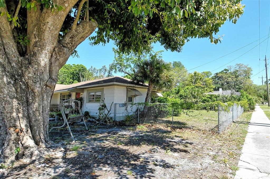1504 Cocoanut Avenue Sarasota, FL 34236 - Photo 3 of 10 a view of a wooden house with a yard and large trees