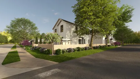 a front view of a house with a yard and trees