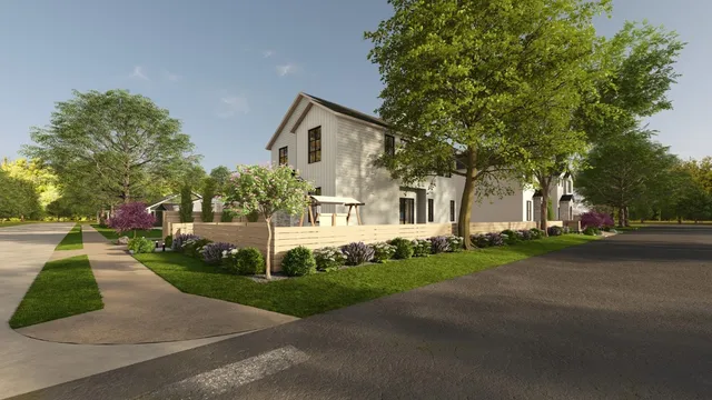 a front view of a house with a yard and trees