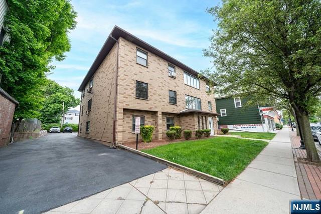 141 Park Avenue, Unit 8A East Rutherford, NJ 07073 - Photo 19 of 22 a view of a white house with a yard