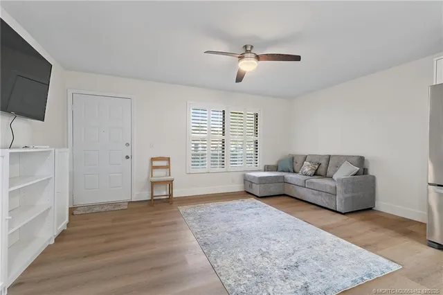a living room with furniture and kitchen view