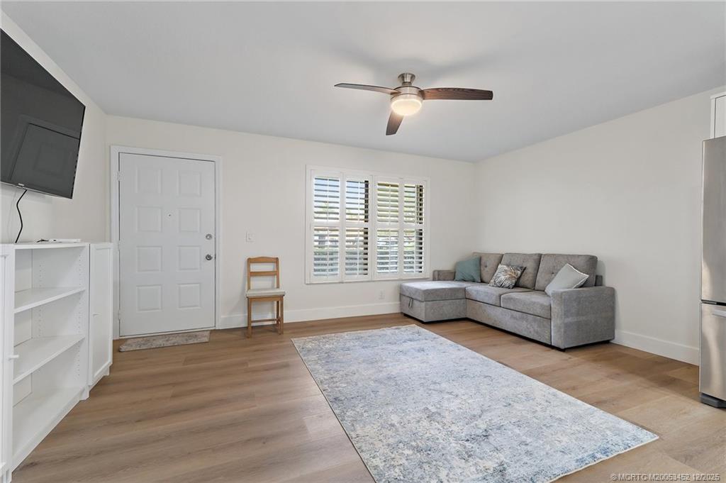 511 Southwest South River Drive, Unit 104 Stuart, FL 34997 - Photo 11 of 61 a living room with furniture and a flat screen tv