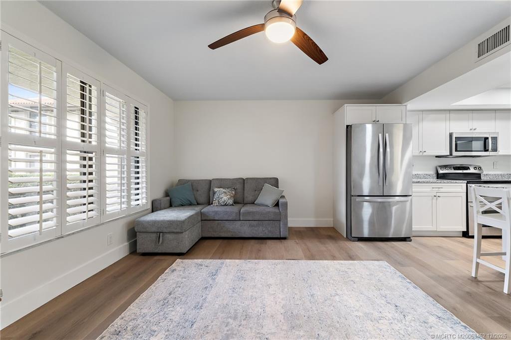 511 Southwest South River Drive, Unit 104 Stuart, FL 34997 - Photo 12 of 61 a living room with furniture and a window