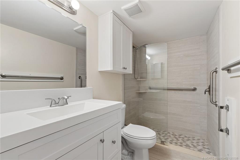 511 Southwest South River Drive, Unit 104 Stuart, FL 34997 - Photo 24 of 61 a bathroom with a sink toilet and shower
