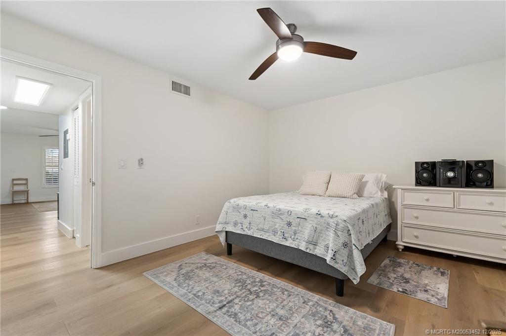 511 Southwest South River Drive, Unit 104 Stuart, FL 34997 - Photo 30 of 61 a bedroom with a bed and a view of bedroom