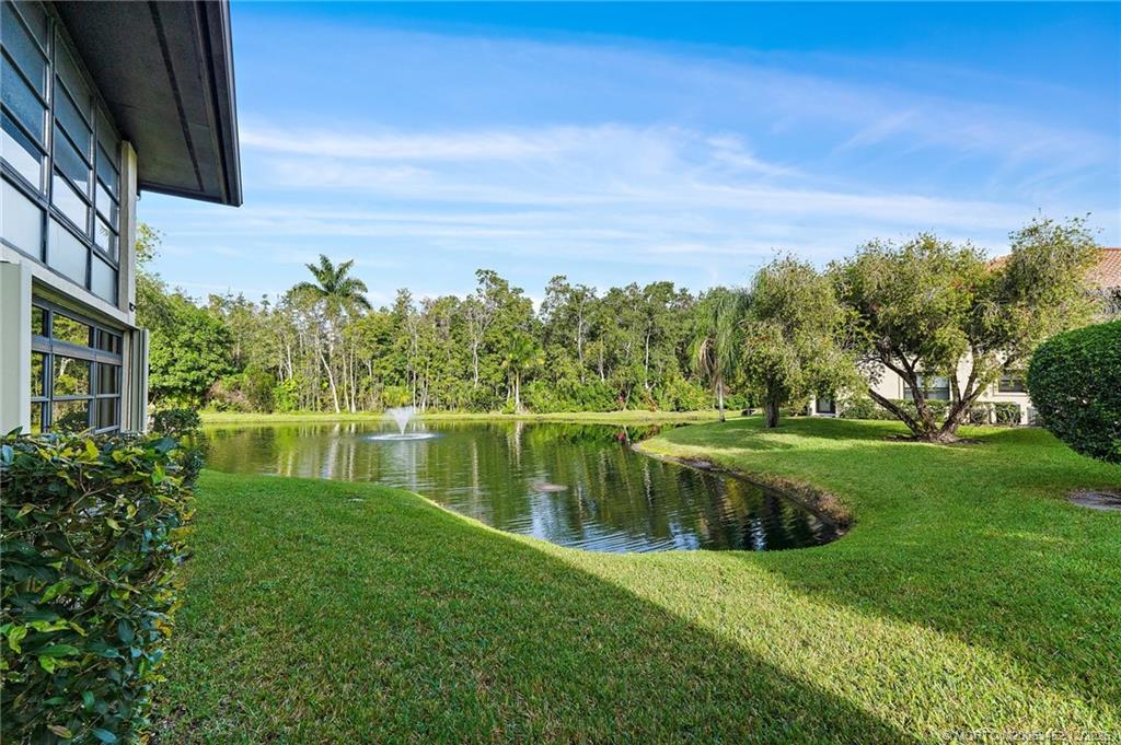 511 Southwest South River Drive, Unit 104 Stuart, FL 34997 - Photo 34 of 61 a view of a lake with a house in the background