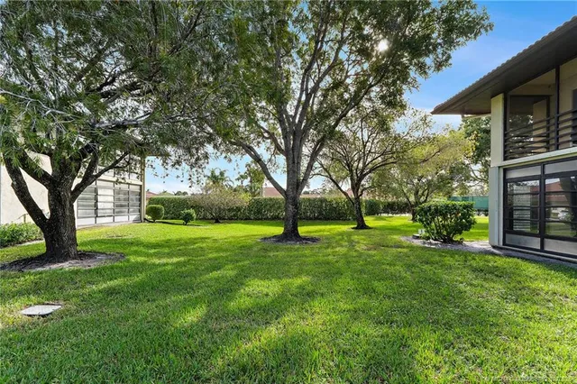 a living room with furniture and a book shelf