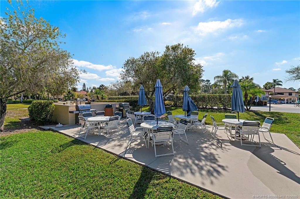 511 Southwest South River Drive, Unit 104 Stuart, FL 34997 - Photo 39 of 61 a view of a backyard with sitting area