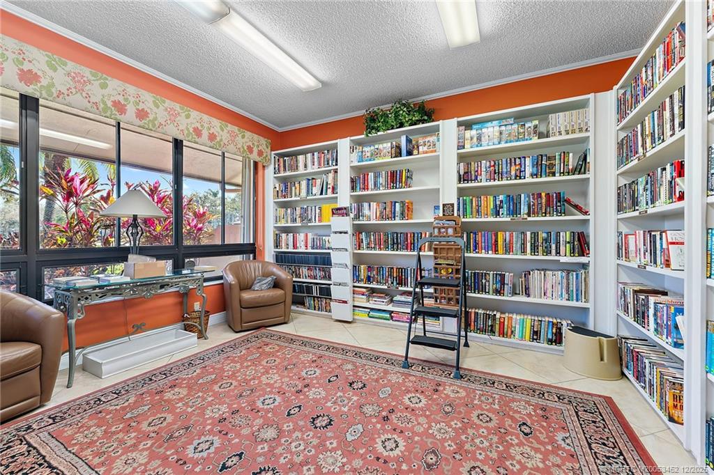 511 Southwest South River Drive, Unit 104 Stuart, FL 34997 - Photo 41 of 61 a living room with furniture and a book shelf