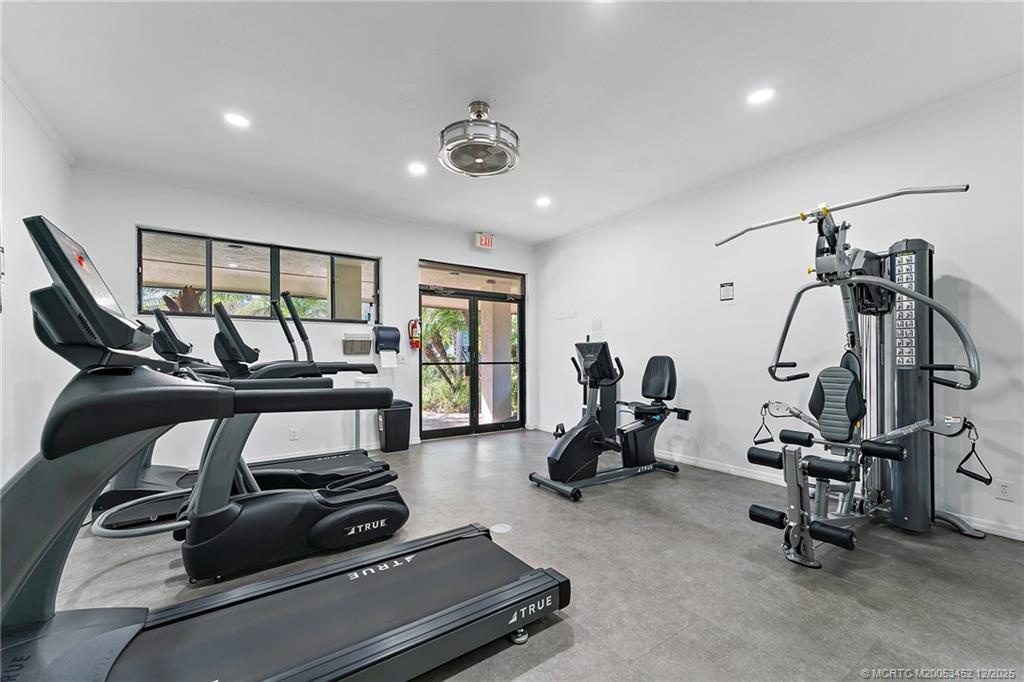 511 Southwest South River Drive, Unit 104 Stuart, FL 34997 - Photo 45 of 61 a room with gym equipment and windows