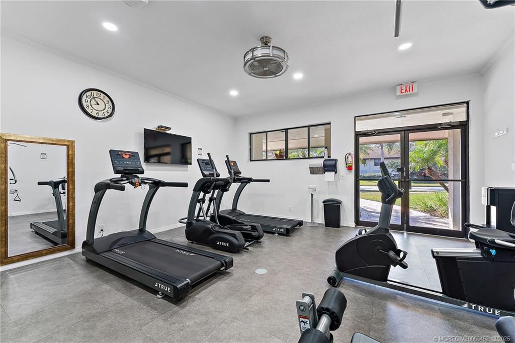 511 Southwest South River Drive, Unit 104 Stuart, FL 34997 - Photo 46 of 61 a room with gym equipment and a large window