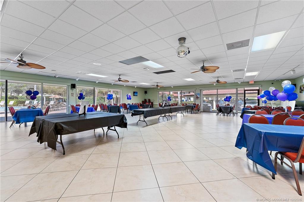 511 Southwest South River Drive, Unit 104 Stuart, FL 34997 - Photo 48 of 61 a living room with lots of furniture and clutter