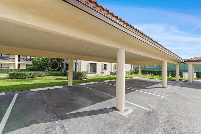 a view of a hallway with wooden cabinets and potted plant