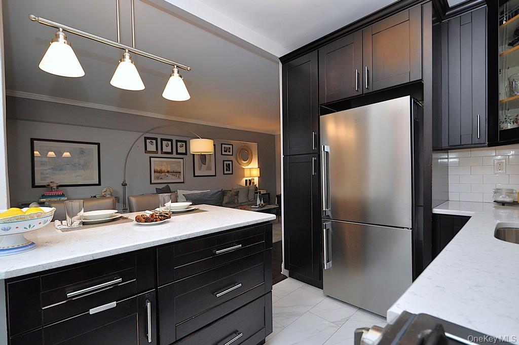 281 Garth Road, Unit A5L Scarsdale, NY 10583 - Photo 12 of 46 a kitchen with a refrigerator and countertop sink