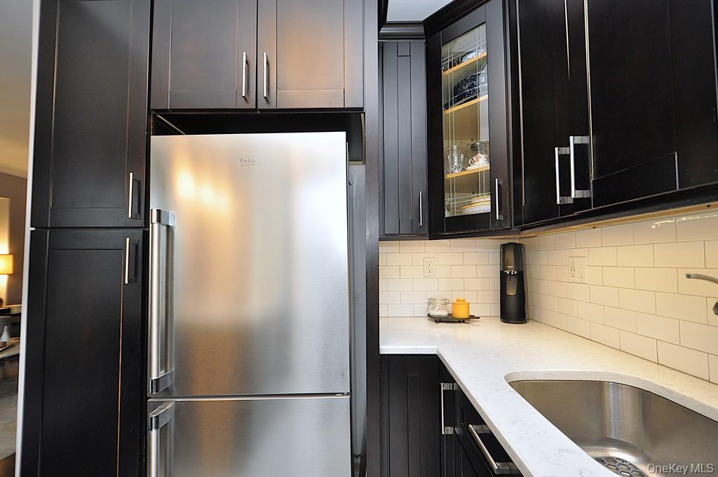 281 Garth Road, Unit A5L Scarsdale, NY 10583 - Photo 15 of 46 a kitchen with a refrigerator and a sink