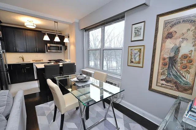 a view of a dining room with furniture a couch and wooden floor