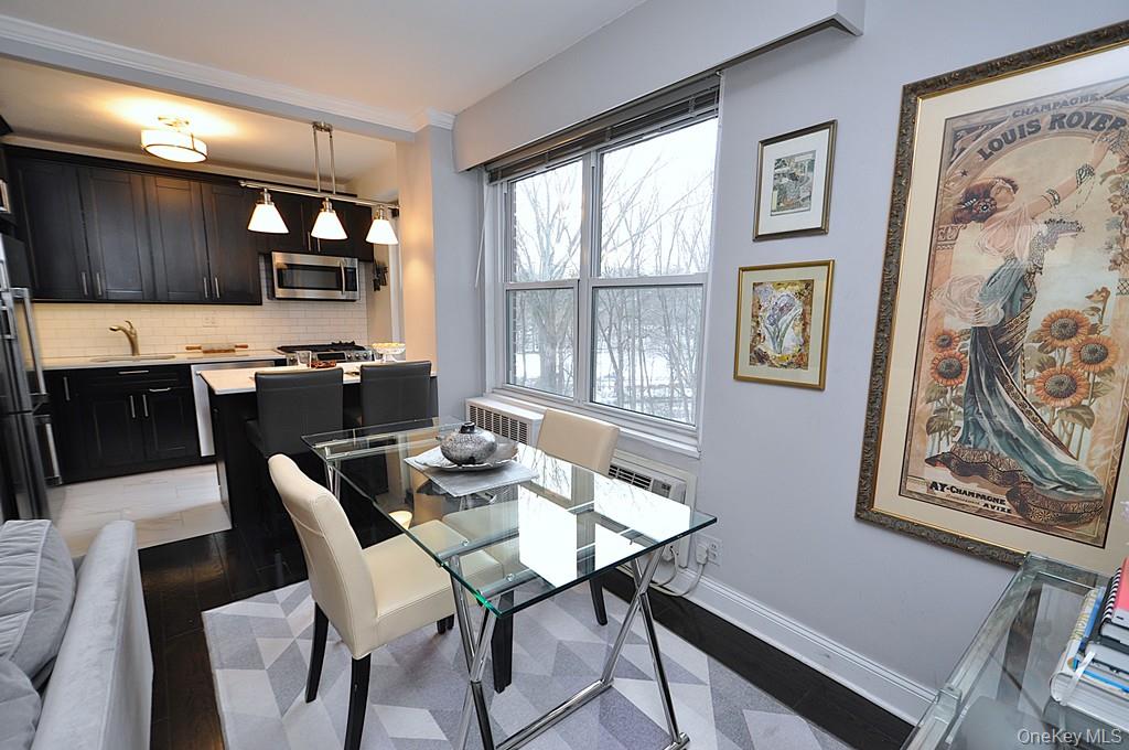 281 Garth Road, Unit A5L Scarsdale, NY 10583 - Photo 18 of 46 a view of a dining room with furniture a couch and wooden floor