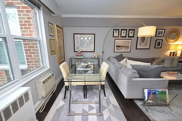 a living room with furniture and a floor to ceiling window