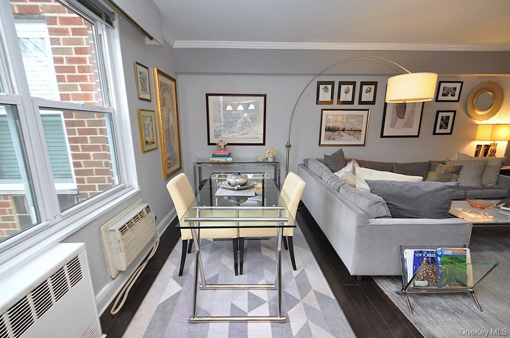 281 Garth Road, Unit A5L Scarsdale, NY 10583 - Photo 22 of 46 a living room with furniture and a floor to ceiling window