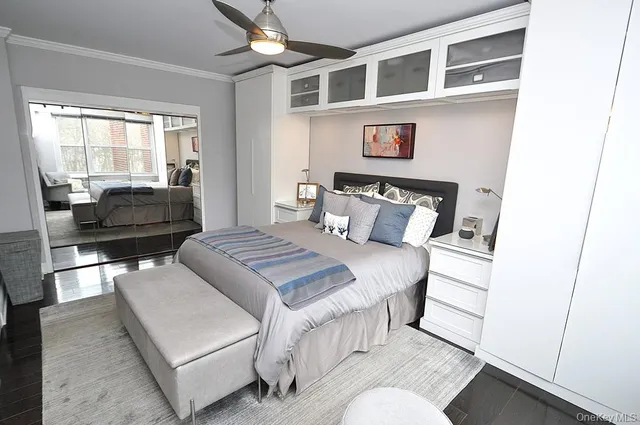 a bedroom with a bed and a large window