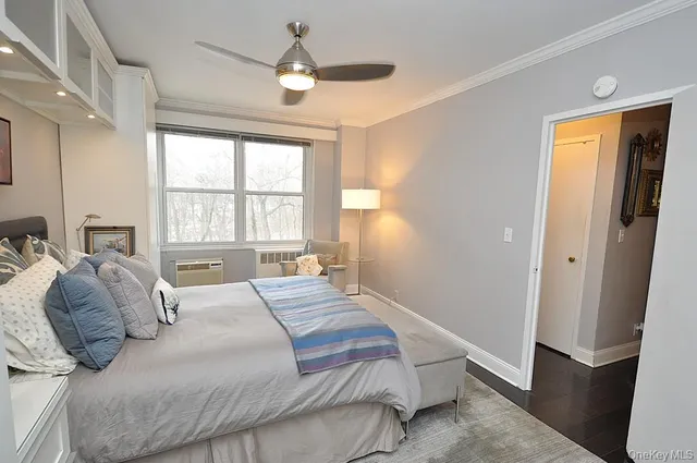 a bedroom with a large bed and a window