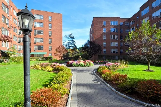 a front view of a multi story building with yard