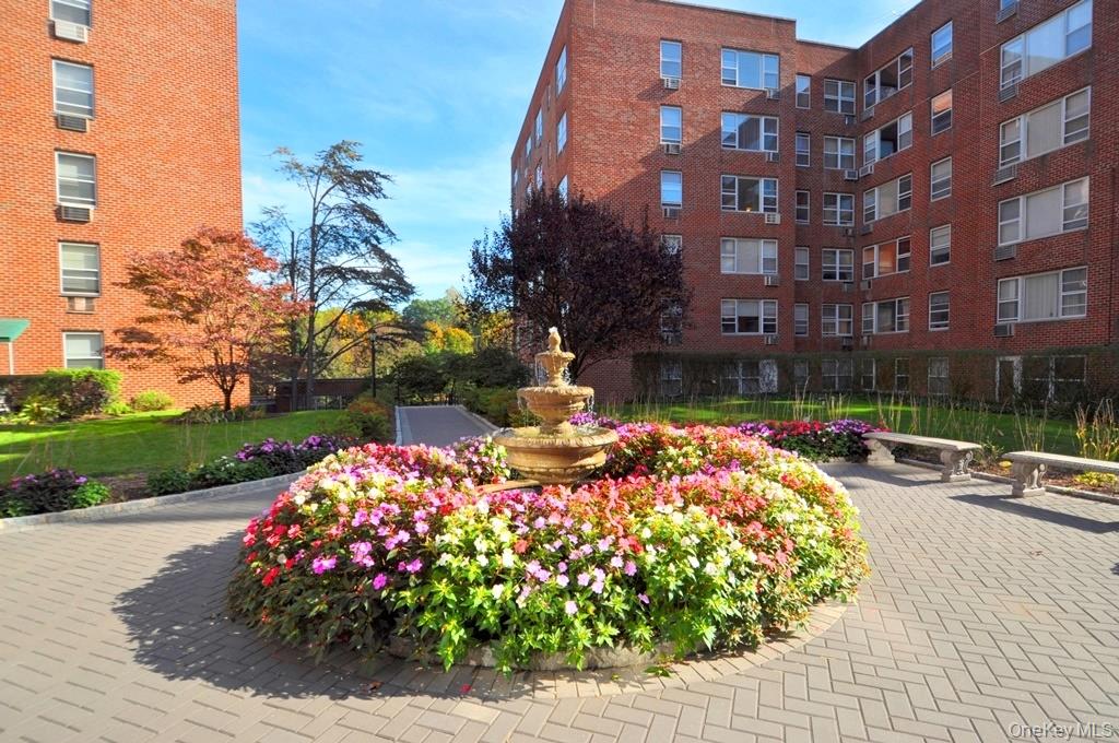 281 Garth Road, Unit A5L Scarsdale, NY 10583 - Photo 36 of 46 a front view of a building with garden
