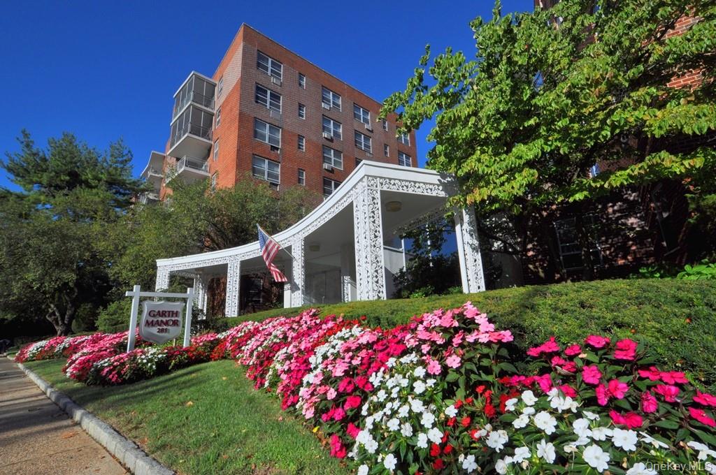 281 Garth Road, Unit A5L Scarsdale, NY 10583 - Photo 5 of 46 a front view of a house with a yard and fountain
