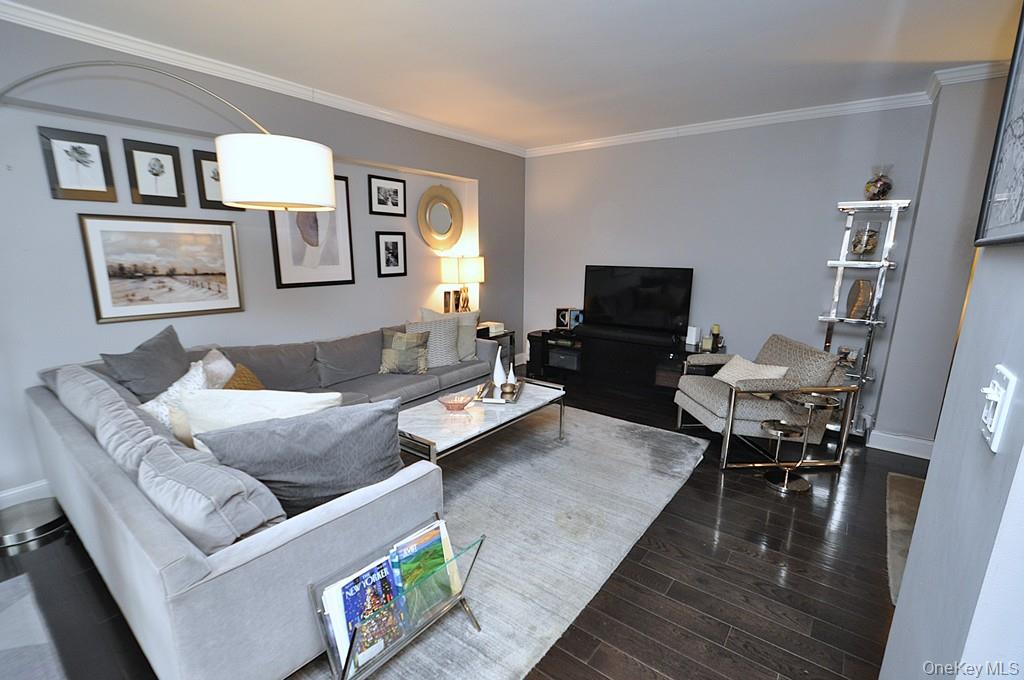 281 Garth Road, Unit A5L Scarsdale, NY 10583 - Photo 7 of 46 a living room with furniture and a flat screen tv