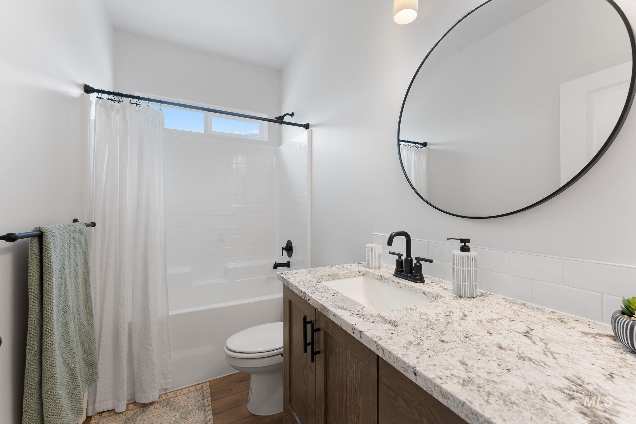 2220 Great Basin Way Burley, ID 83318 - Photo 31 of 39 Bathroom featuring vanity, shower / bath combination with curtain, and dark wood finished floors