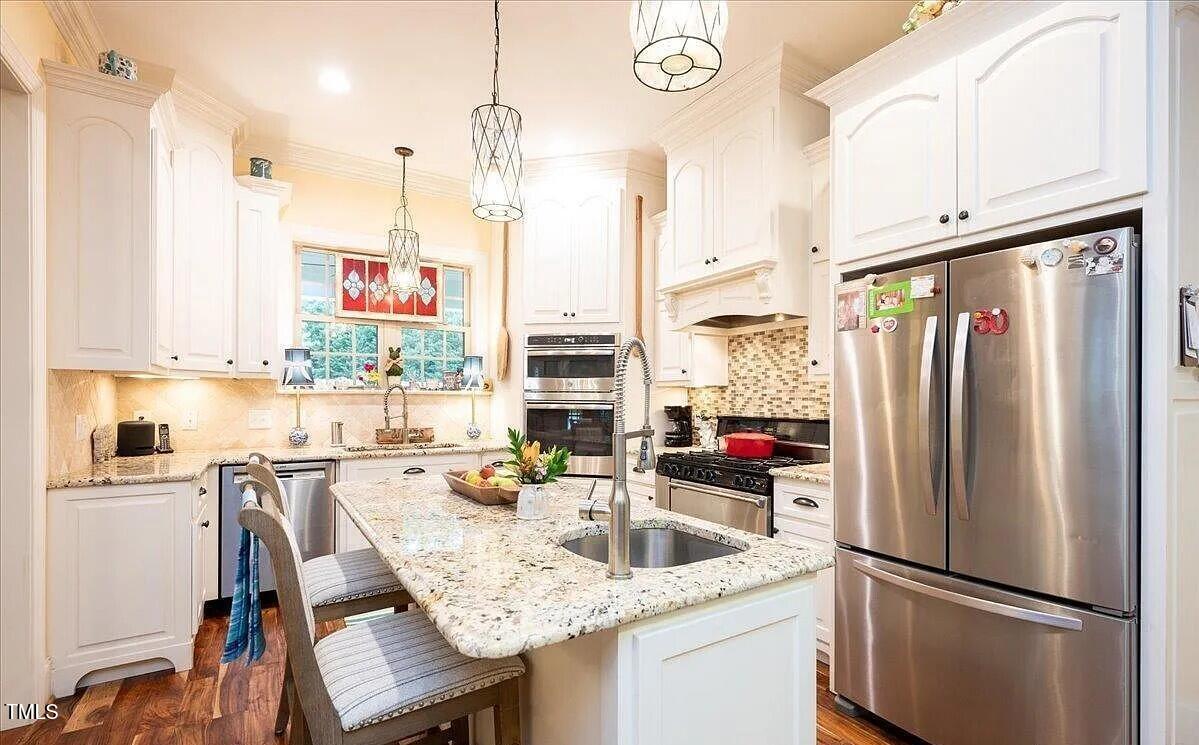 413 Johnson Town Road Zebulon, NC 27597 - Photo 11 of 52 a kitchen with stainless steel appliances granite countertop a refrigerator and a sink