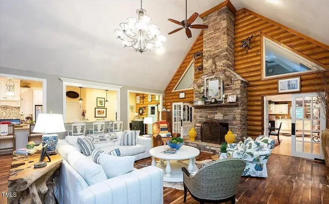 a living room with fireplace furniture and a chandelier