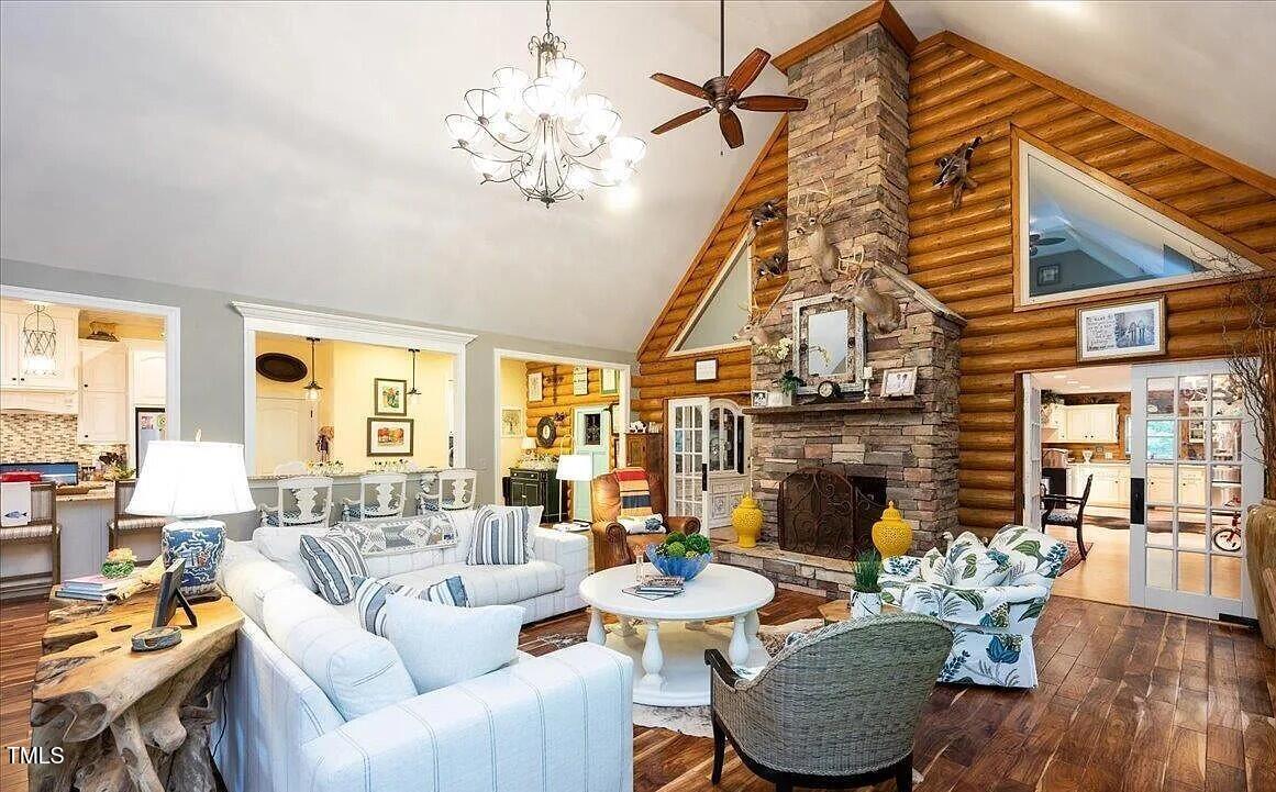 413 Johnson Town Road Zebulon, NC 27597 - Photo 16 of 52 a living room with fireplace furniture and a chandelier