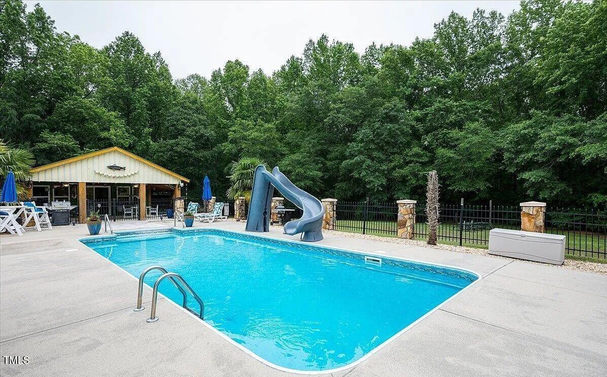 413 Johnson Town Road Zebulon, NC 27597 - Photo 2 of 52 swimming pool view with a seating space