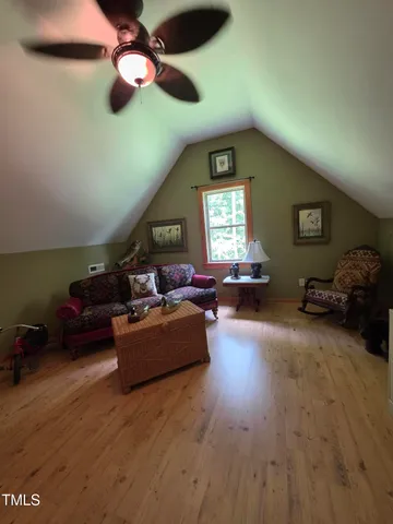 a spacious bedroom with a bed and a chandelier