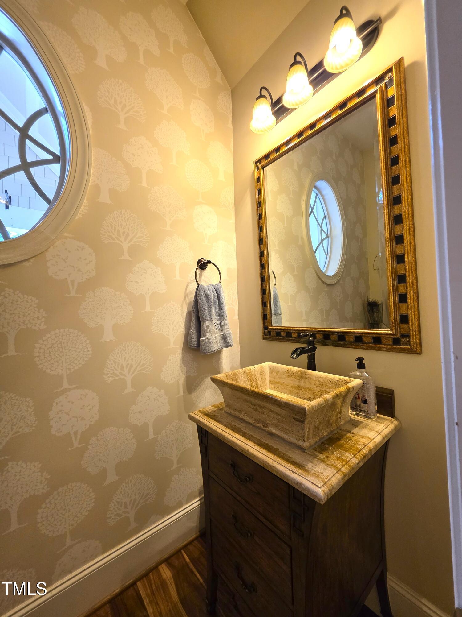 413 Johnson Town Road Zebulon, NC 27597 - Photo 39 of 52 a bathroom with a sink and a mirror
