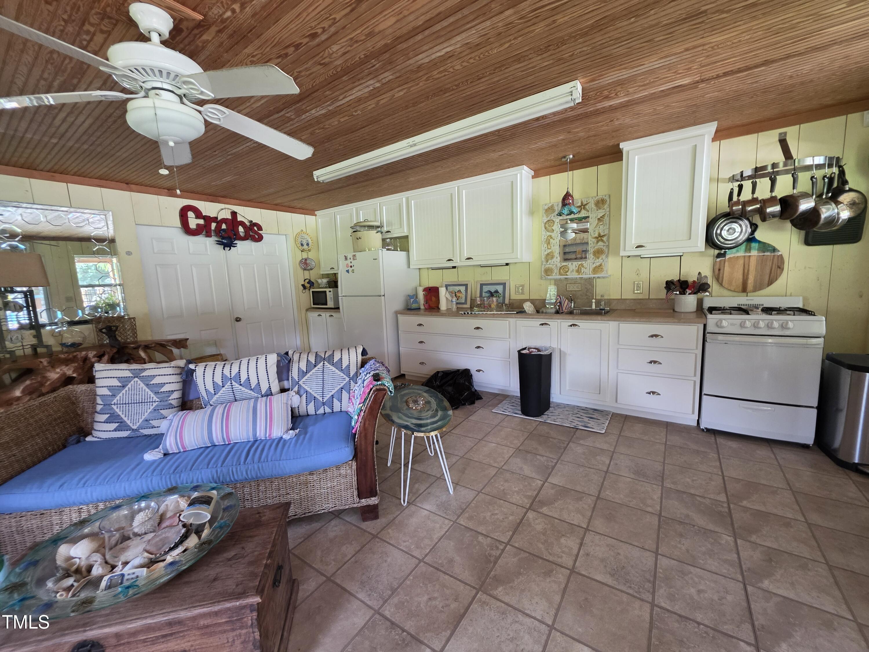 413 Johnson Town Road Zebulon, NC 27597 - Photo 44 of 52 a large white kitchen with a large window