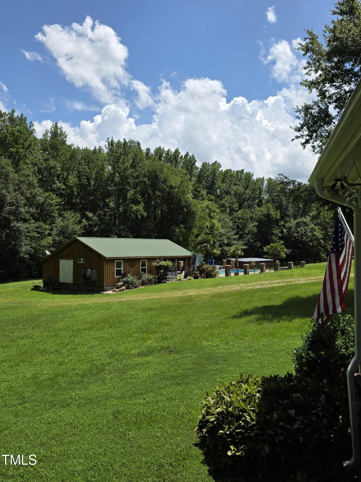 413 Johnson Town Road Zebulon, NC 27597 - Photo 51 of 52 a front view of a house with a garden