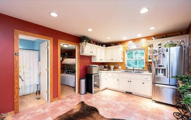 a kitchen with stainless steel appliances kitchen island granite countertop a refrigerator and a stove top oven