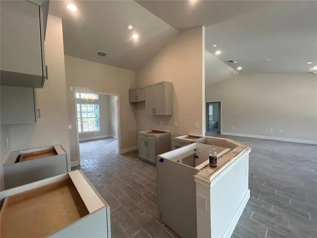 a kitchen that has a sink and a stove in it