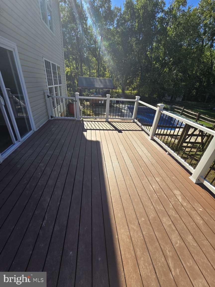 10 Osprey Lane Middletown, DE 19709 - Photo 4 of 25 a balcony with wooden floor and outdoor seating