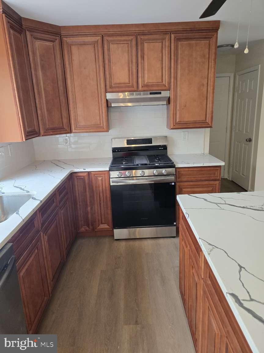 10 Osprey Lane Middletown, DE 19709 - Photo 9 of 25 a kitchen with stainless steel appliances granite countertop a stove a sink and a microwave