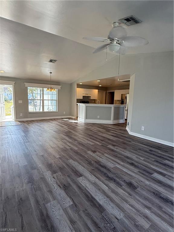 3122 12th Street Southwest Lehigh Acres, FL 33976 - Photo 11 of 19 an empty room with wooden floor and windows