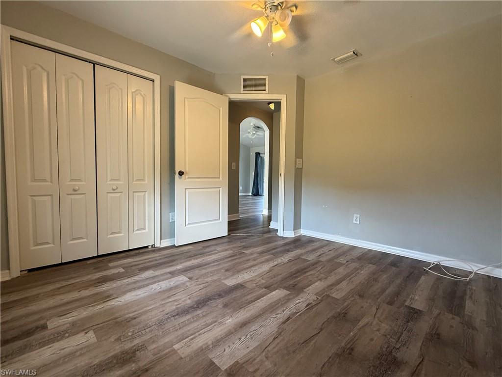 3122 12th Street Southwest Lehigh Acres, FL 33976 - Photo 12 of 19 a view of empty room with wooden floor and fan