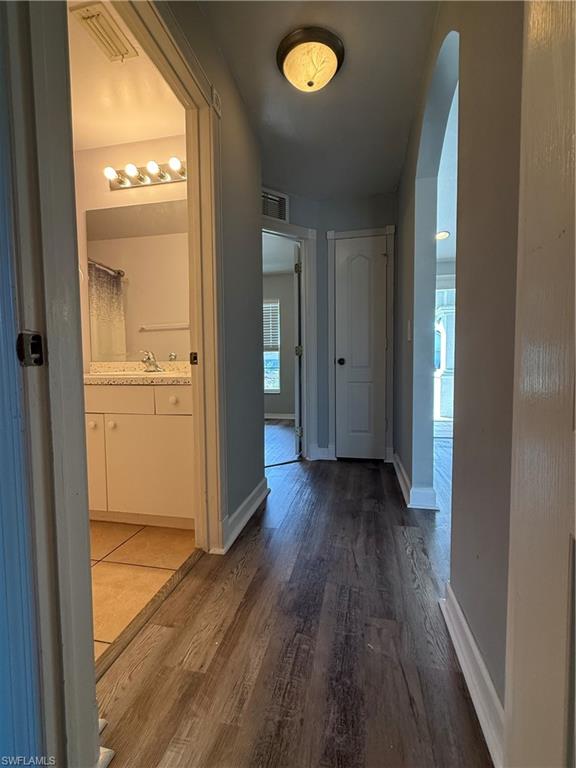 3122 12th Street Southwest Lehigh Acres, FL 33976 - Photo 13 of 19 a view of a hallway with wooden floor